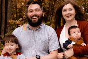 Photo of Family Sitting on Tree Log